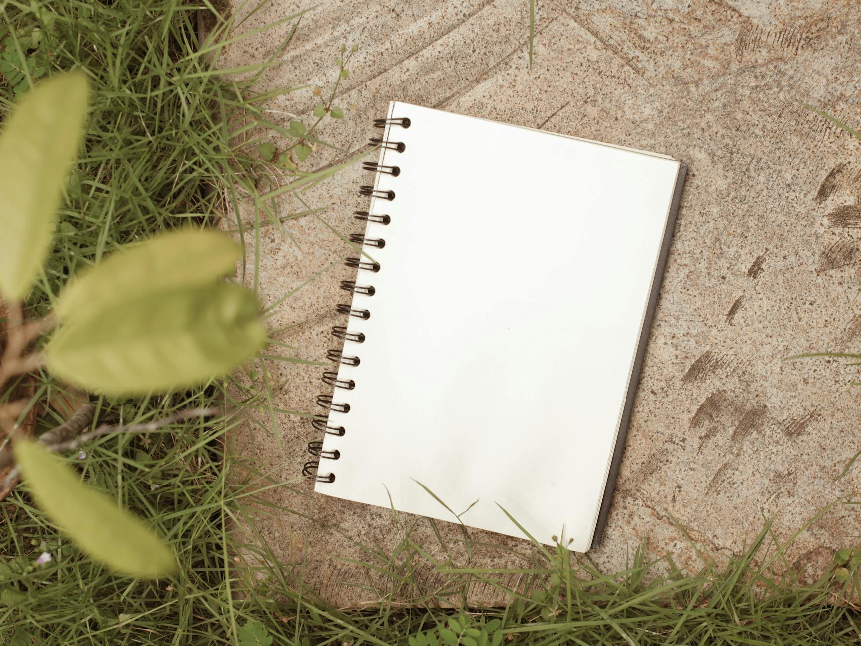 notebook on outdoor concrete floor for journaling