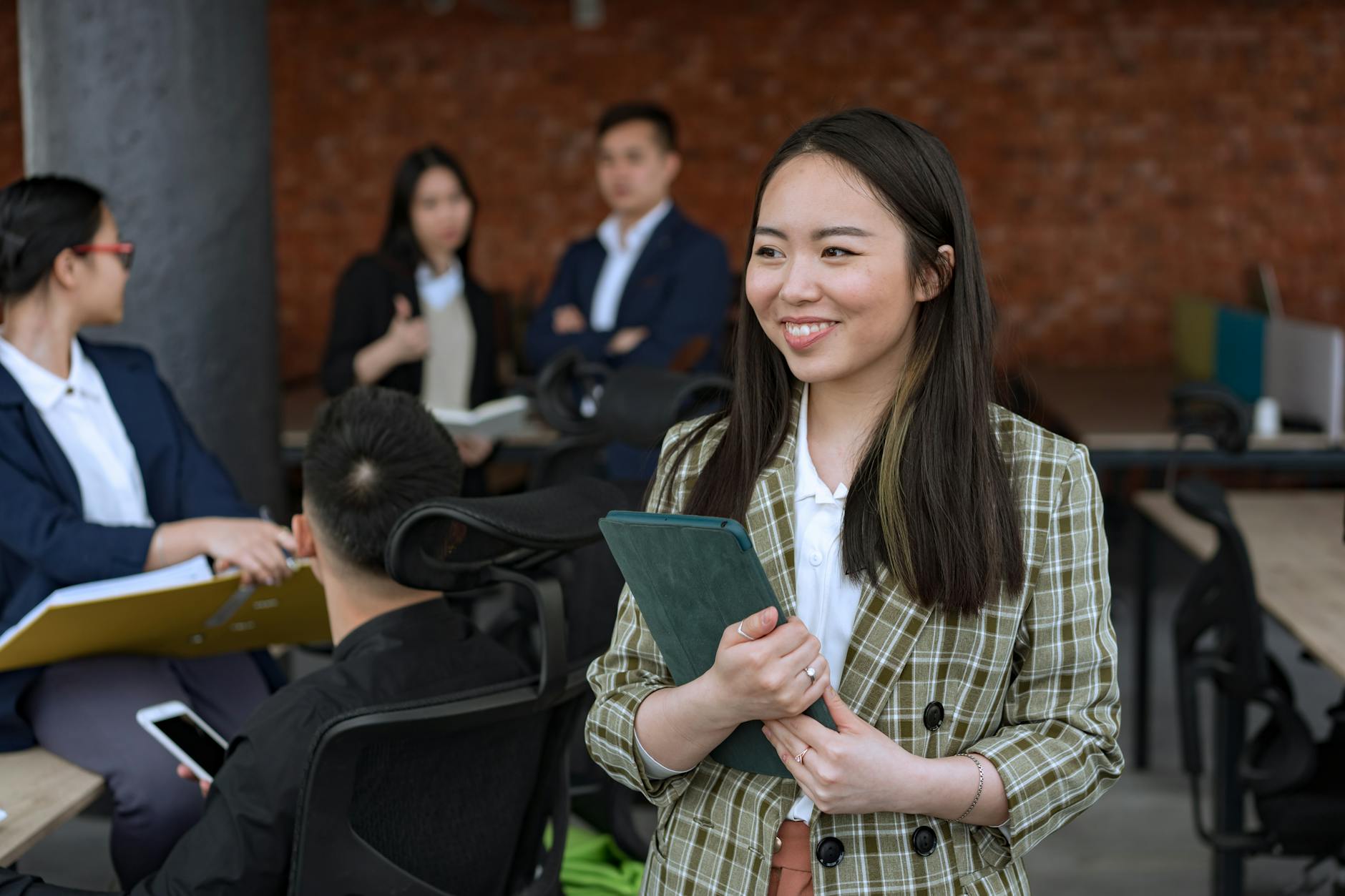 woman in green plaid blazer smiling